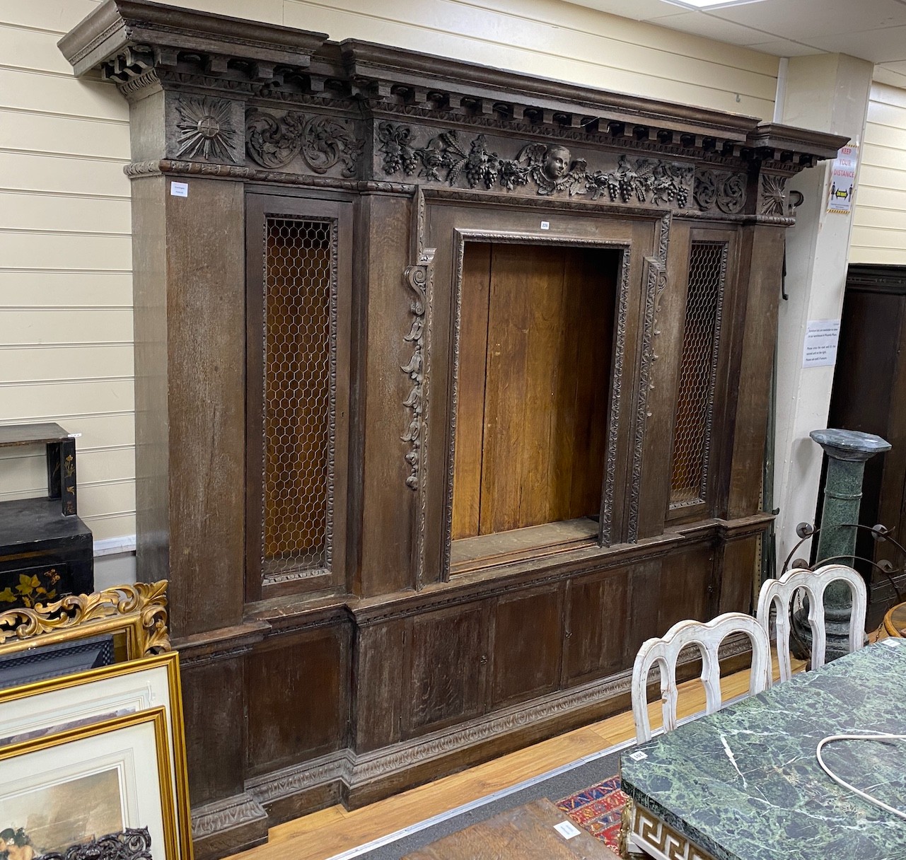 A large 19th century oak breakfront cabinet, with a finely carved frieze, length 280cm, depth 47cm, height 227cm